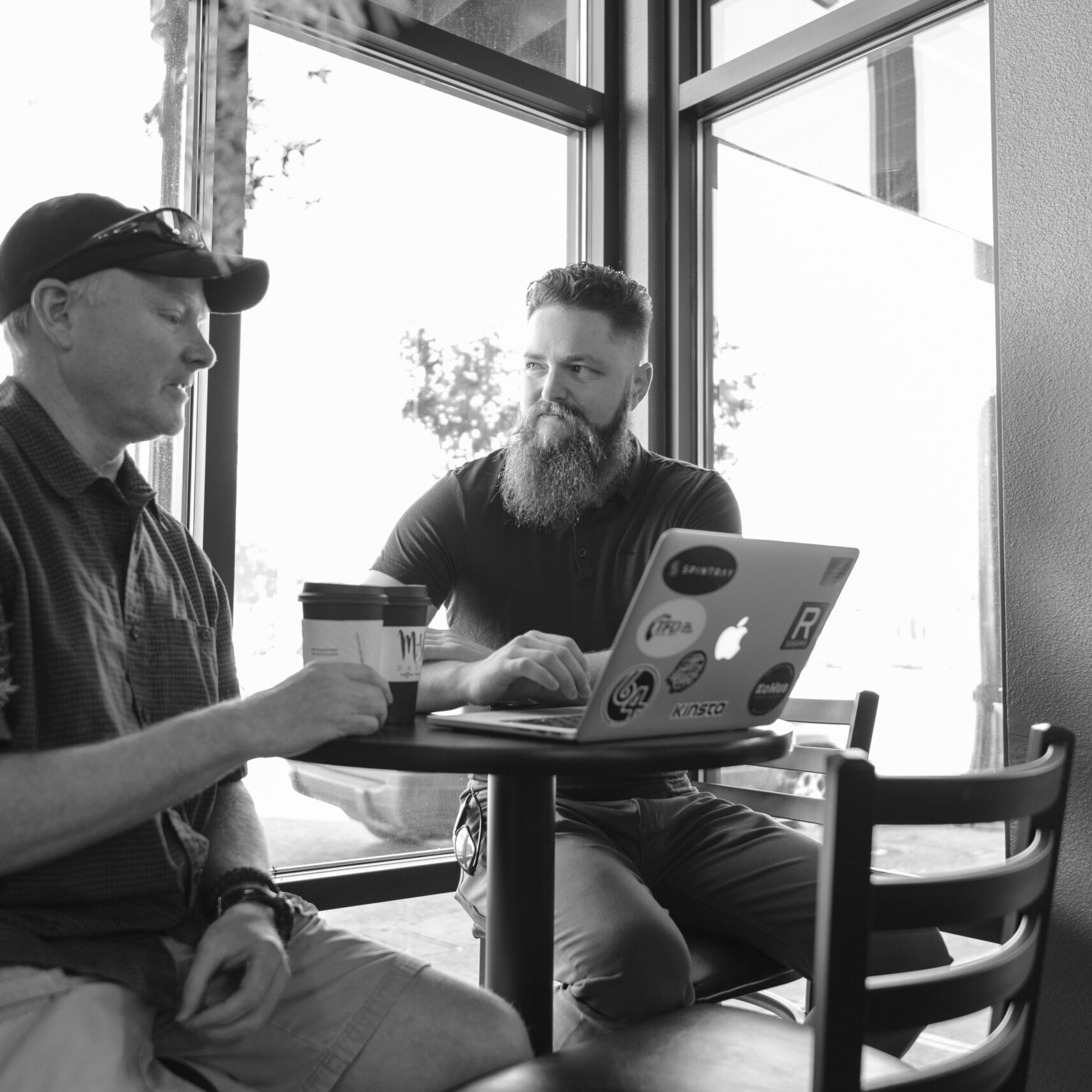 Client and web developer looking at Yakima website design project on laptop